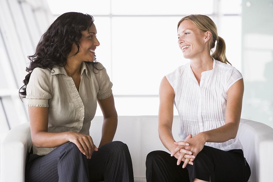 2 women sitting and talking