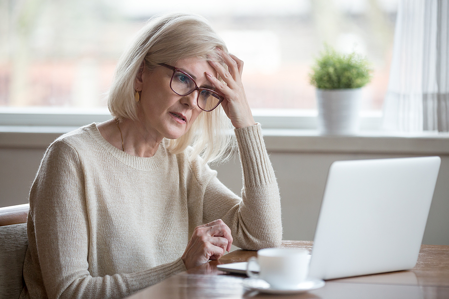 mature woman white hair looking at computer