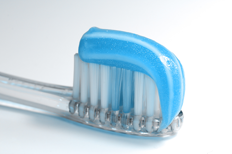 blue toothbrush with toothpaste