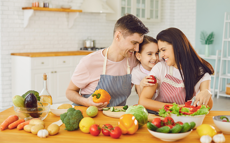 family preparing healthy meals in kitchen