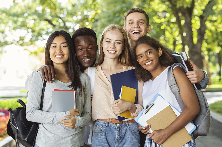 smiling teenage boys and girls