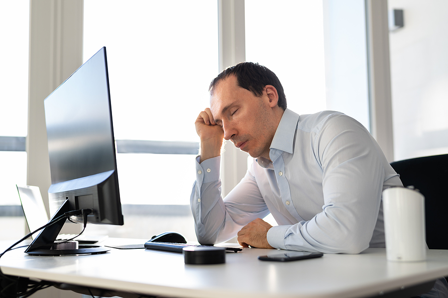 mid age man tired at desk