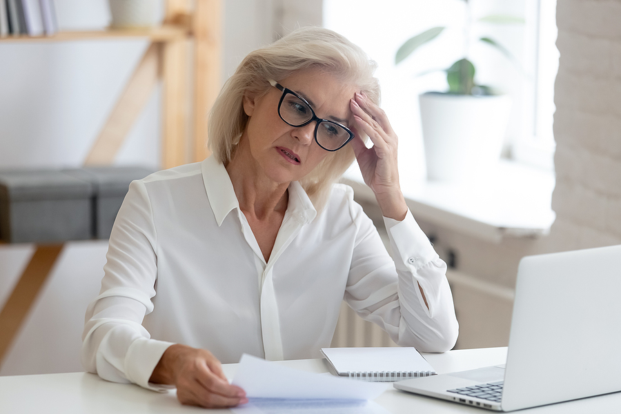 senior woman worried looking at laptop