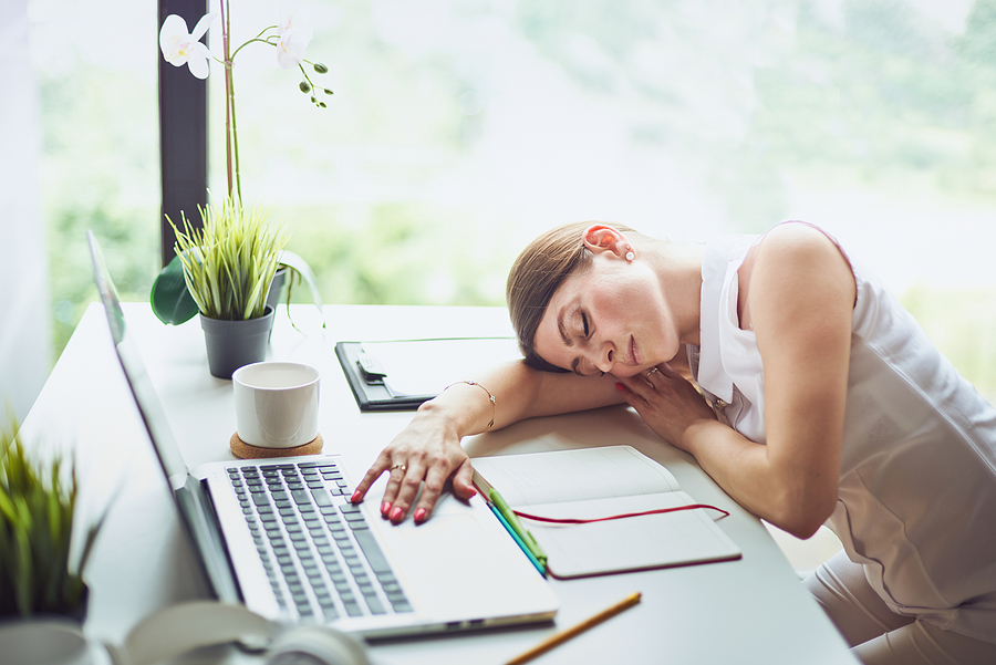 woman tired head on desk