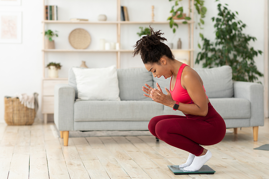 woman happy on scale for weight loss