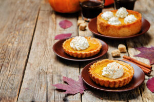 mini pumpkin cheesecakes with cream on top