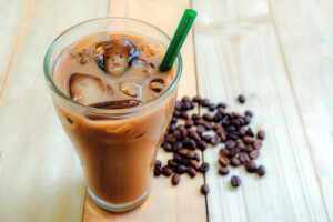 glass of iced mocha coffee with coffee beans