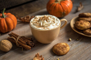 coffee cup with cream and pumpkins