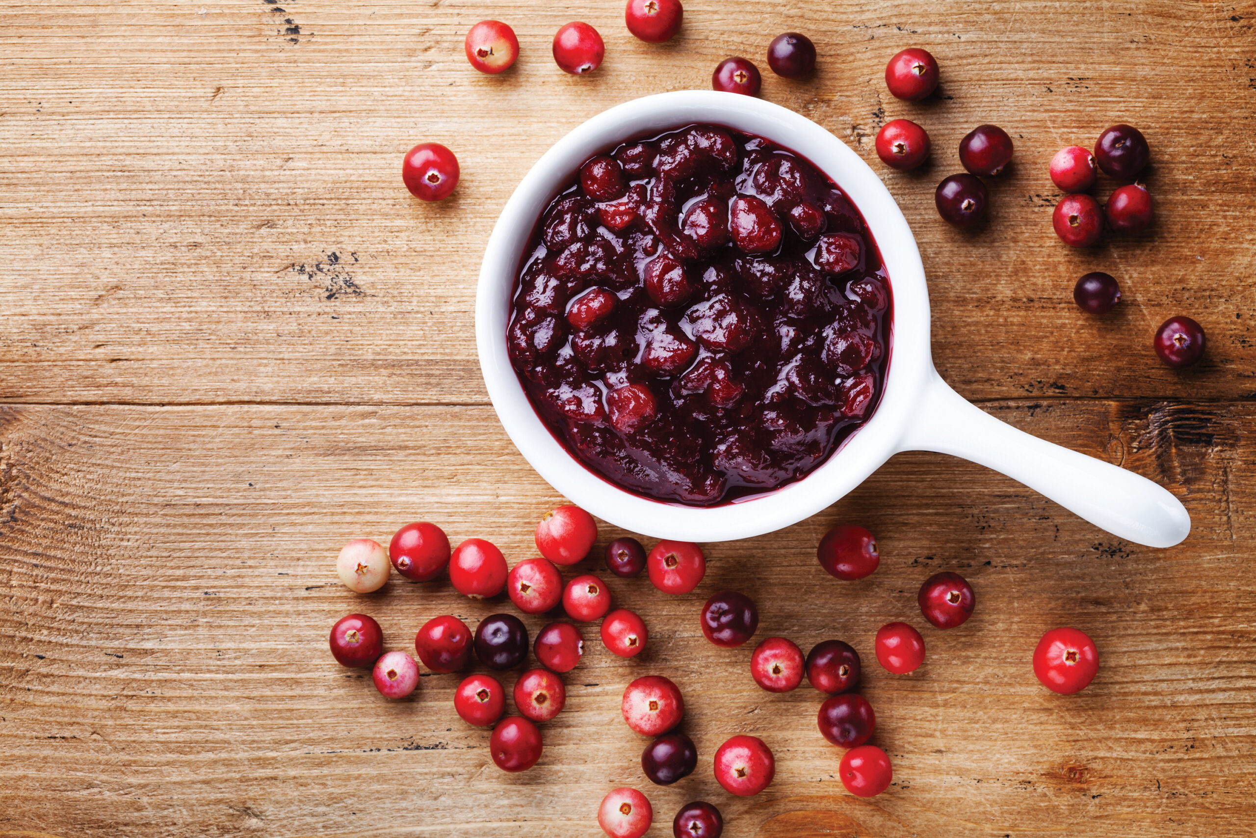 cranberries and sauce in white bowl