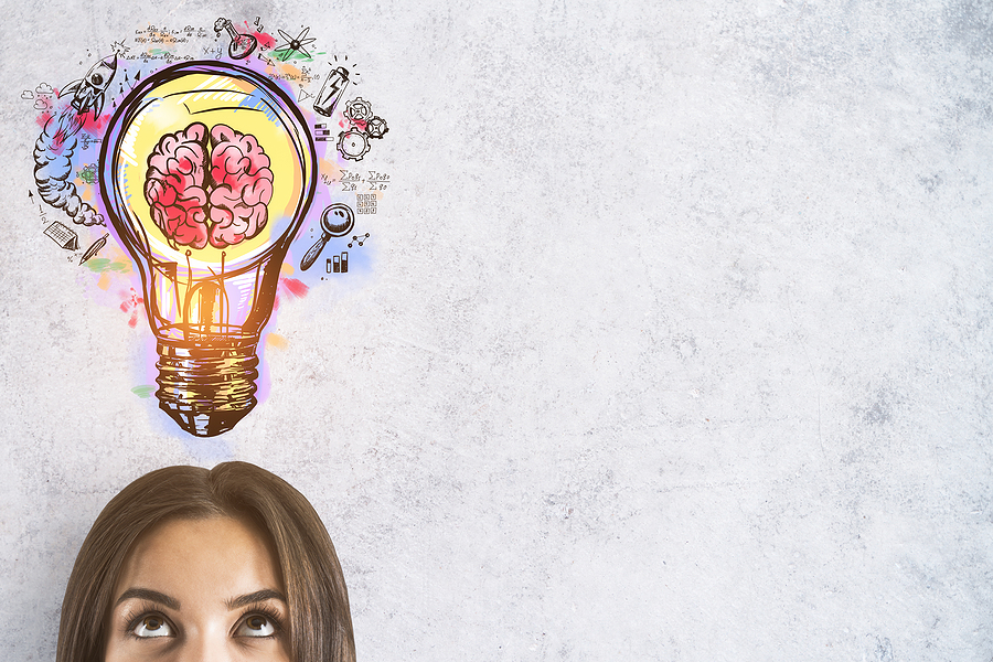 brunette woman - eyes looking up at light bulb with brain in it