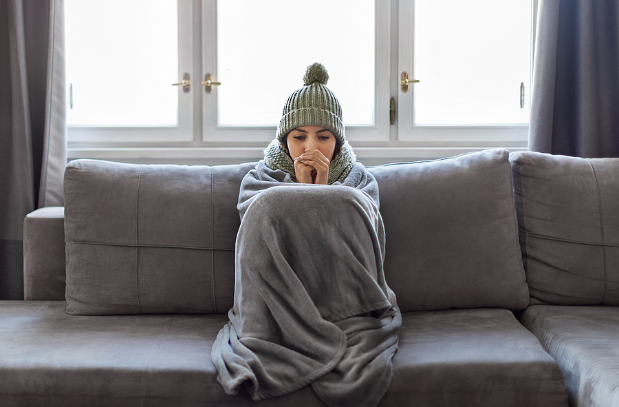 woman with blanket who is freezing