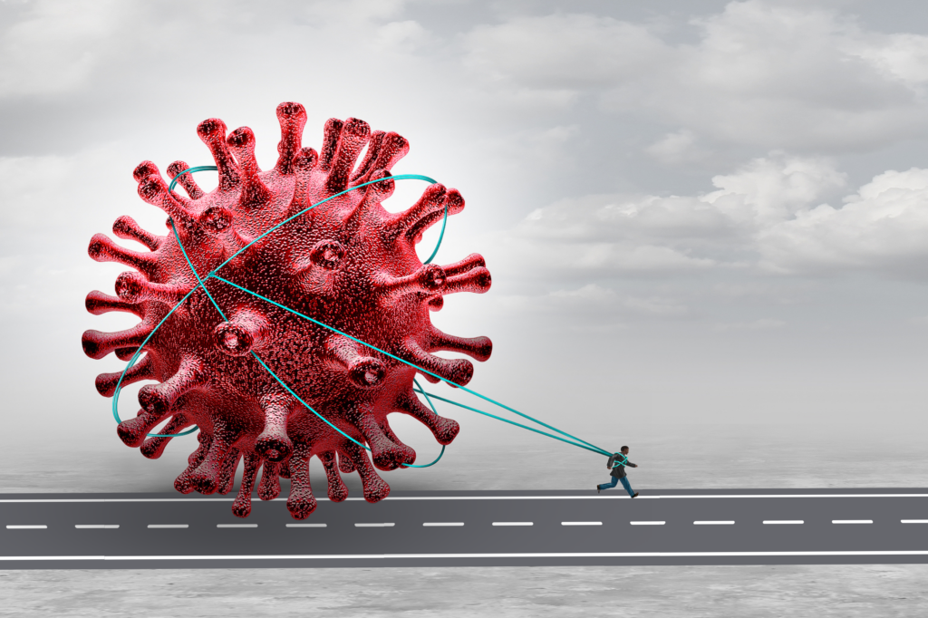 Man dragging a giant Covid virus while running on a long road, symbolizing Long Covid