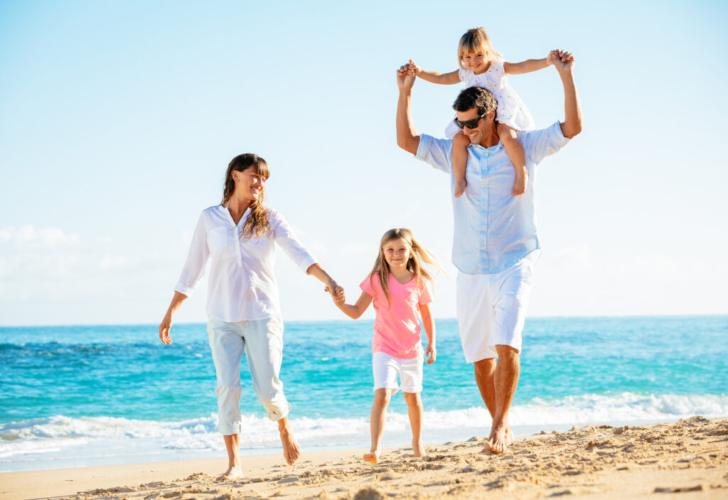 Family having fun on the beach in the summer